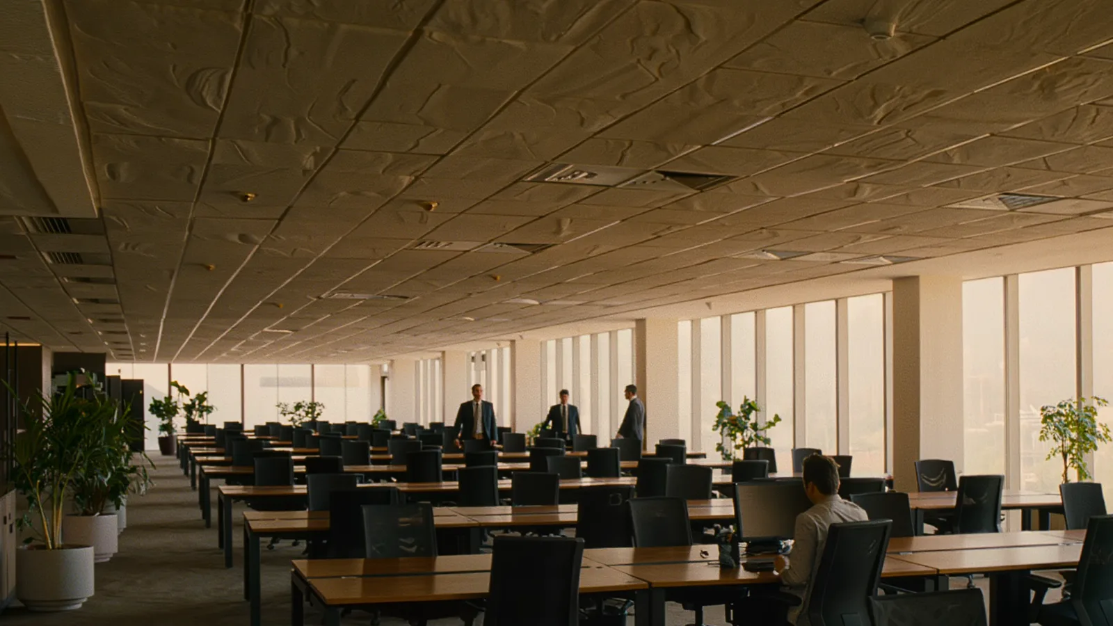 Open-plan campus office floor with employees at their desks