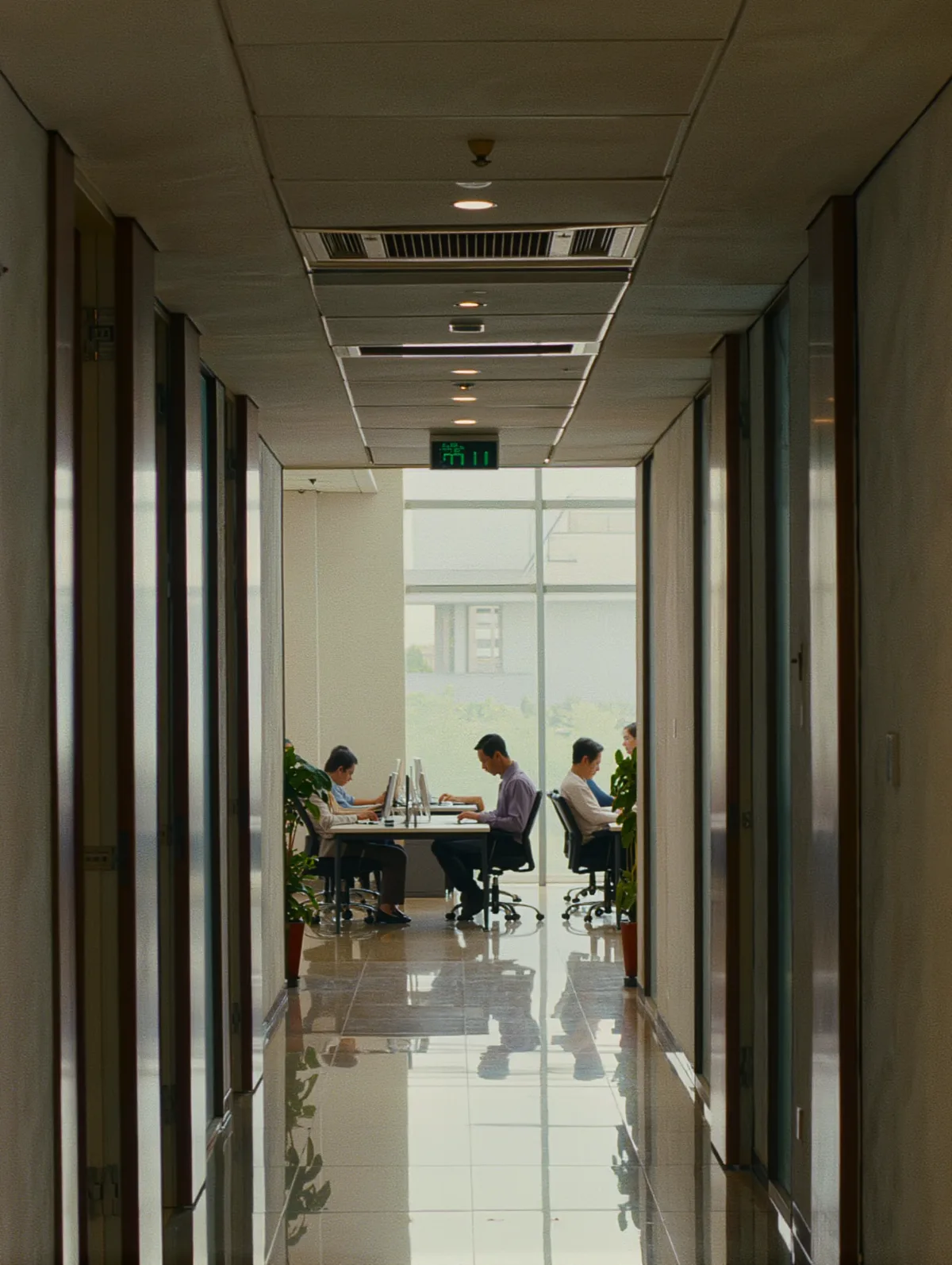 Open-plan office floor with a few employees at their desks
