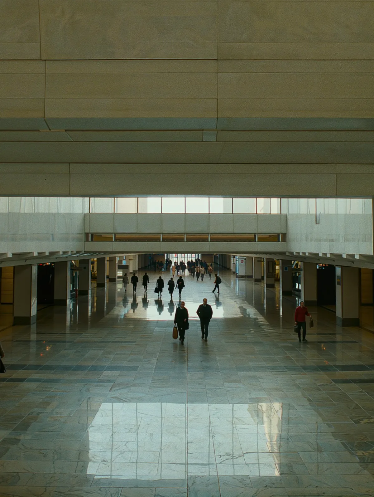 Station concourse seen from above with commuters walking in different directions